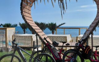 Conway e-bikes parked next to a wooden heart structure on the beach in Obzor Bulgaria