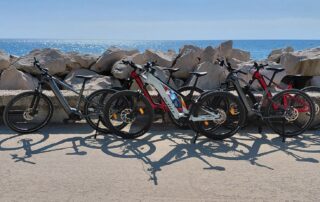 Conway and Scott electric mountain bikes lined up along the rocky coast in Obzor Bulgaria