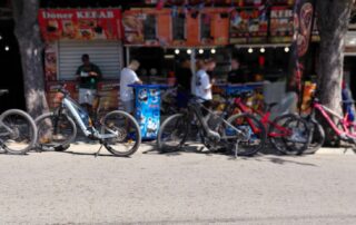 Scott and Conway electric mountain bikes parked outside a local doner kebab shop in Obzor after a tour
